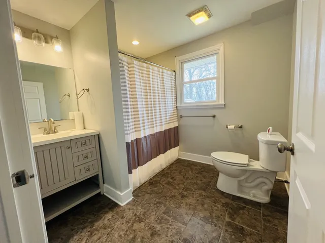 a bathroom with a sink toilet and a tub