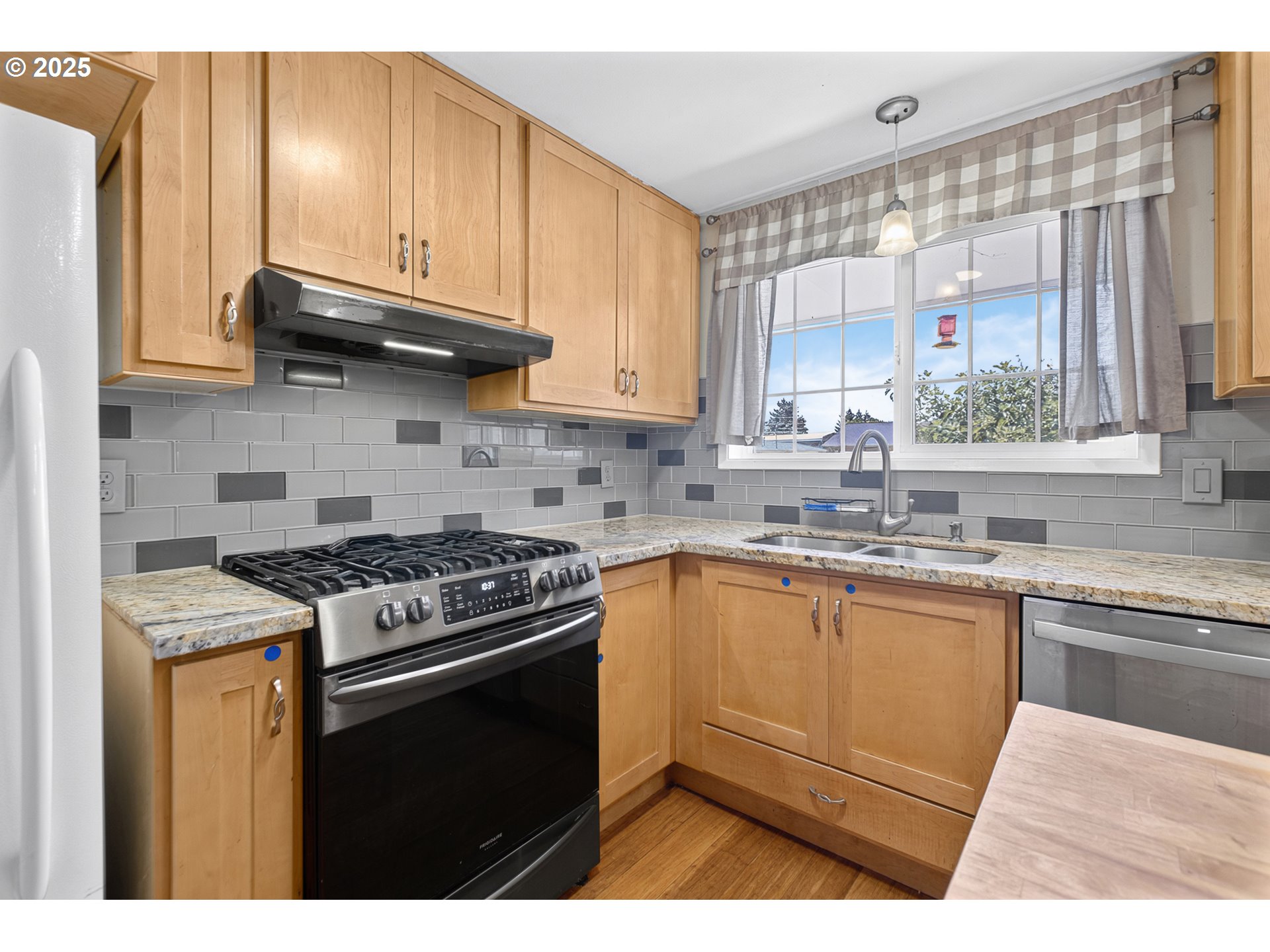 457 Archie Street Eugene, OR 97402 - Photo 13 of 48 a kitchen with stainless steel appliances granite countertop a stove a sink and a microwave