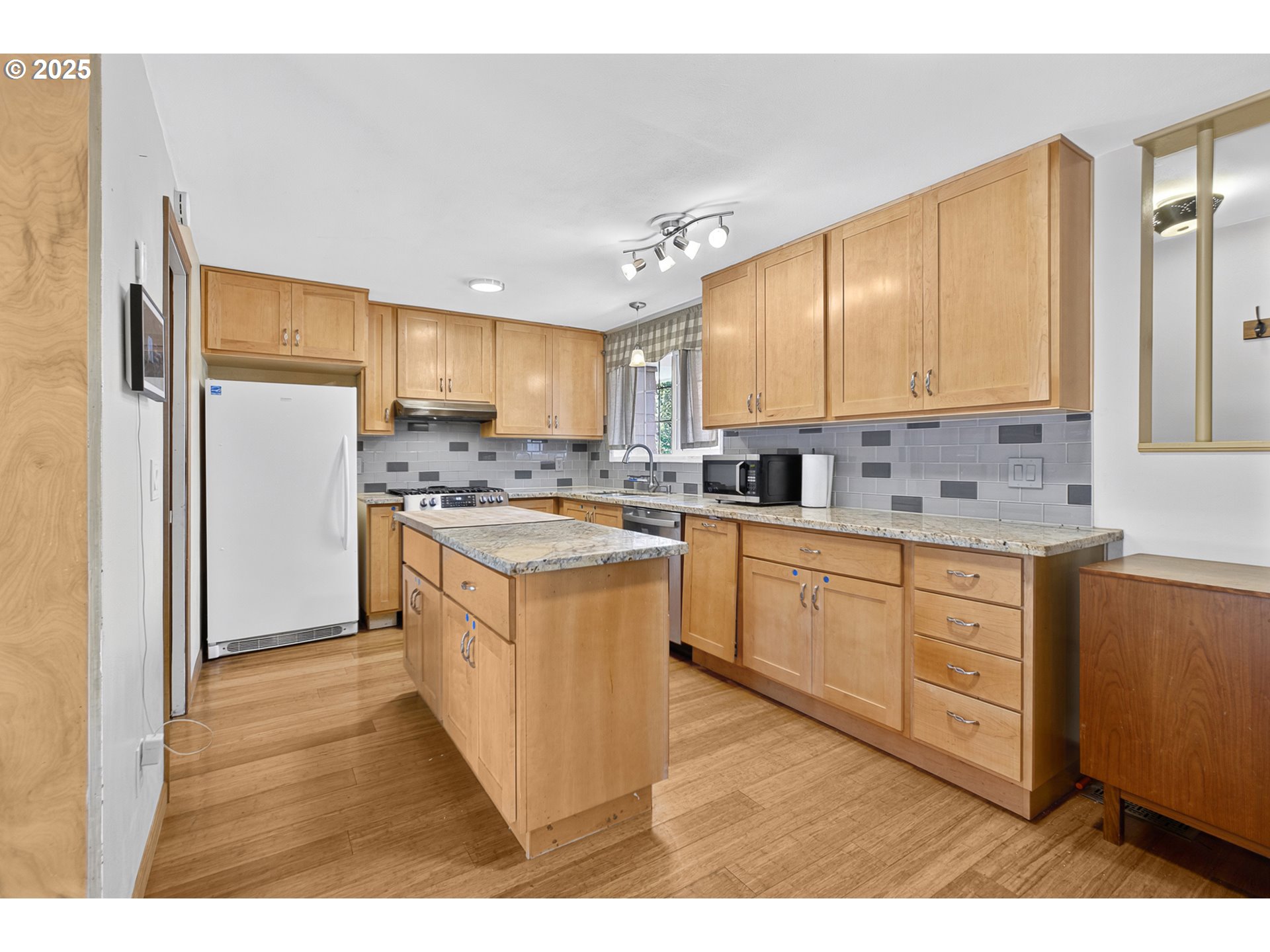457 Archie Street Eugene, OR 97402 - Photo 14 of 48 a kitchen with stainless steel appliances granite countertop a stove a sink dishwasher a refrigerator and cabinets with wooden floor