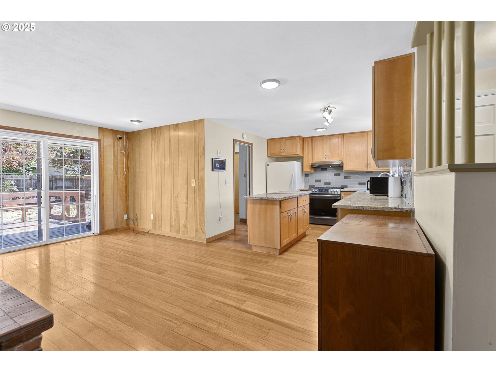 457 Archie Street Eugene, OR 97402 - Photo 15 of 48 a kitchen with stainless steel appliances a refrigerator a sink a stove and white cabinets