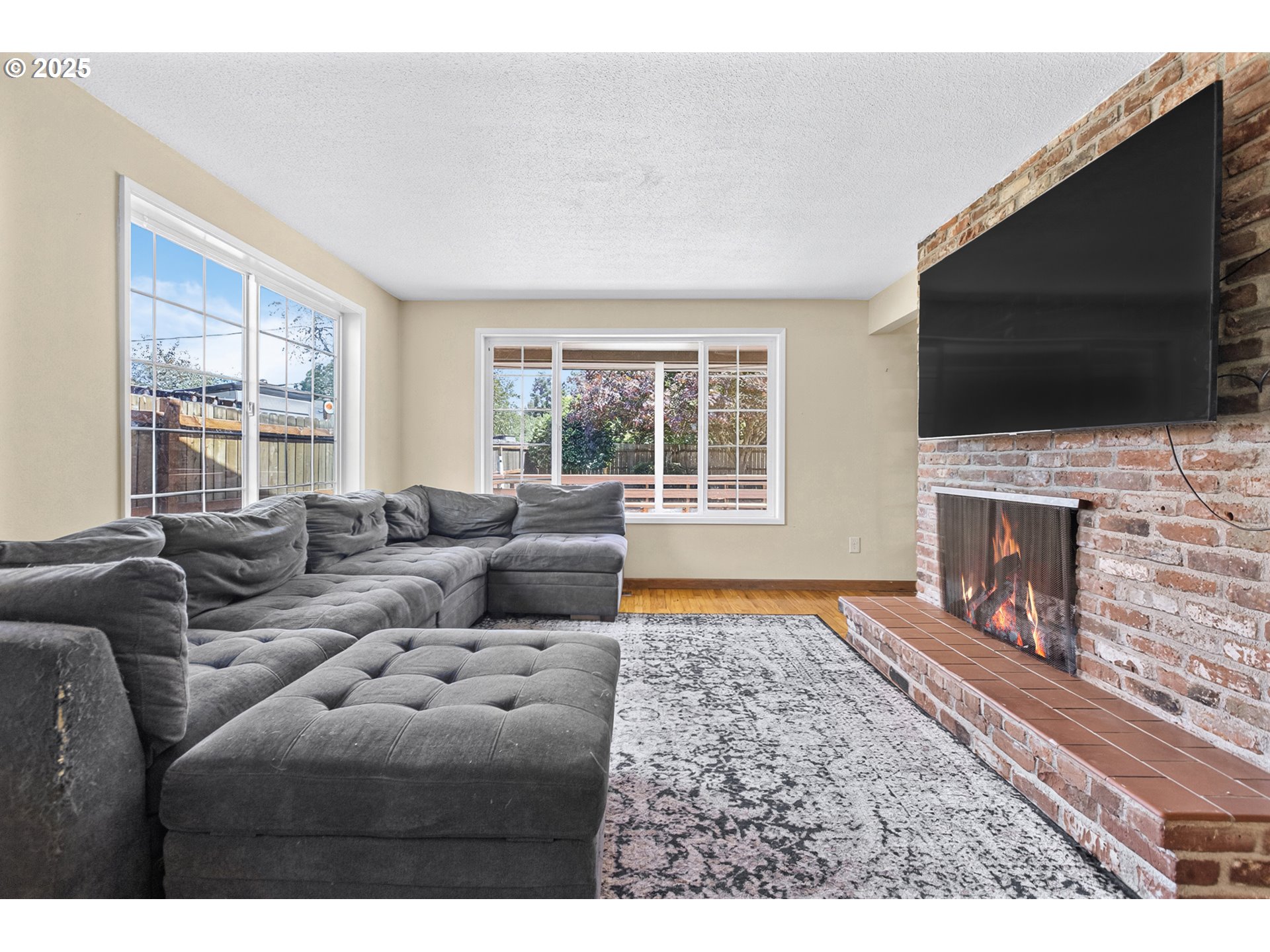 457 Archie Street Eugene, OR 97402 - Photo 16 of 48 a living room with fireplace furniture and a flat screen tv