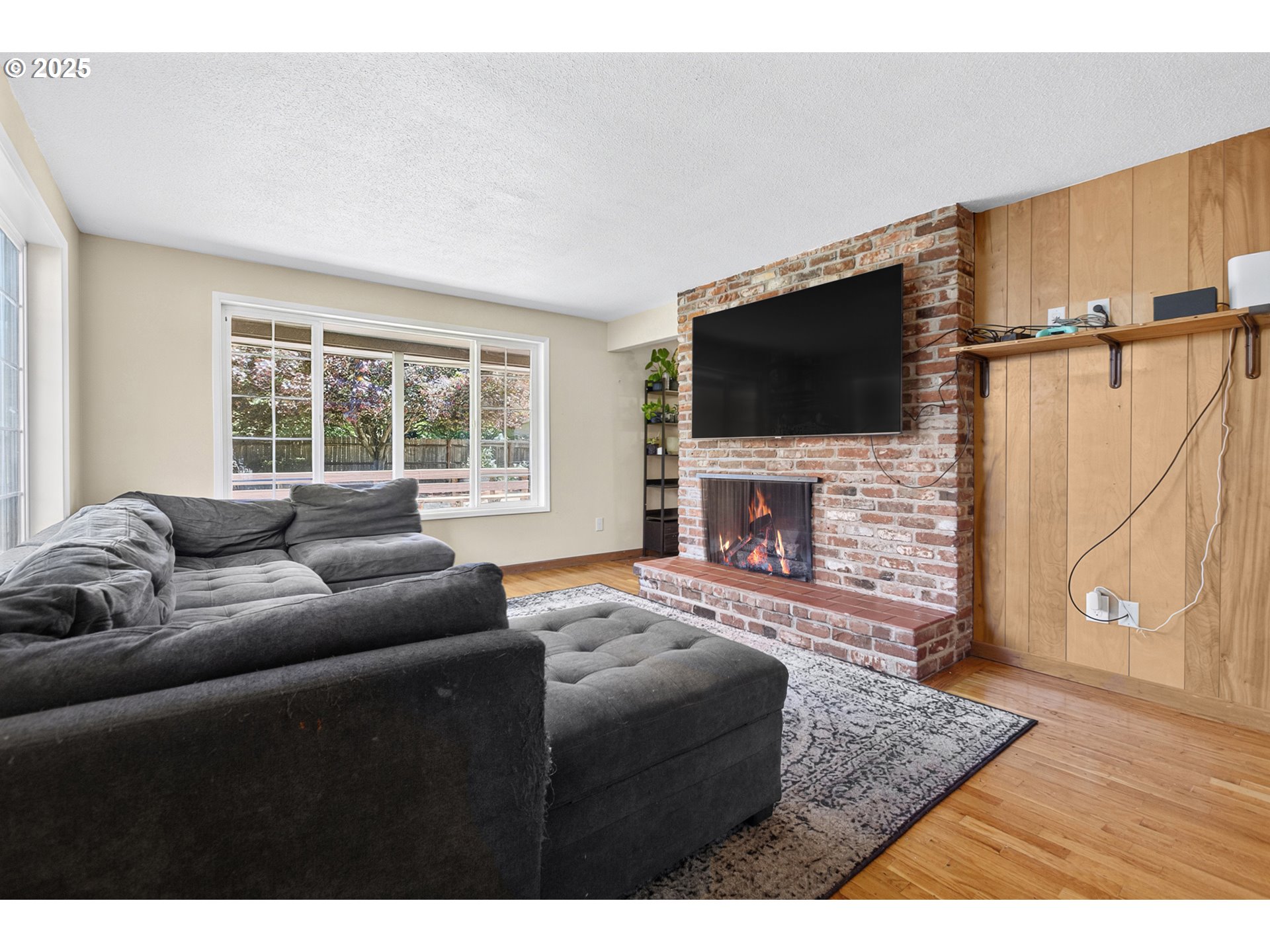 457 Archie Street Eugene, OR 97402 - Photo 17 of 48 a living room with furniture a flat screen tv and a fireplace