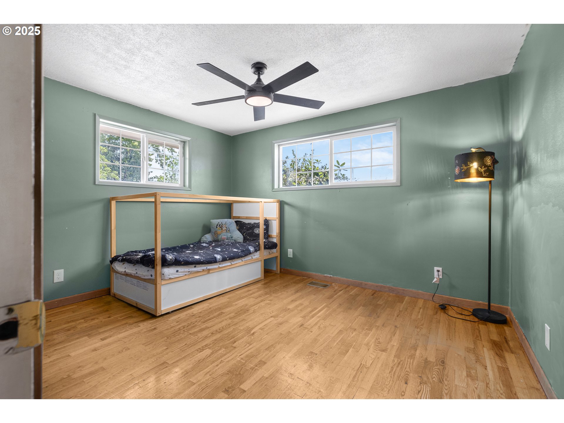 457 Archie Street Eugene, OR 97402 - Photo 24 of 48 a bedroom with a bed and a chandelier