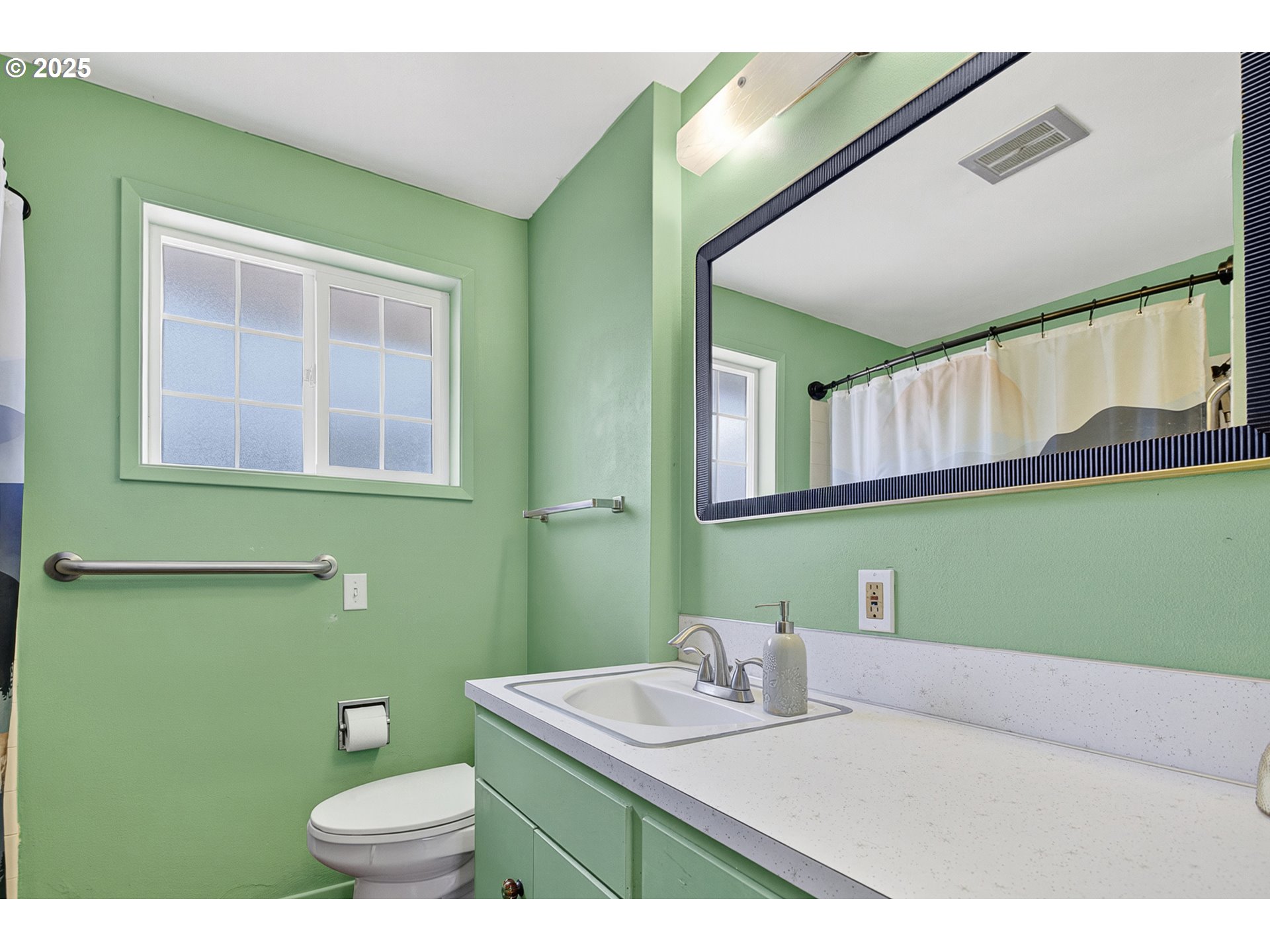 457 Archie Street Eugene, OR 97402 - Photo 27 of 48 a bathroom with a sink a toilet and a mirror