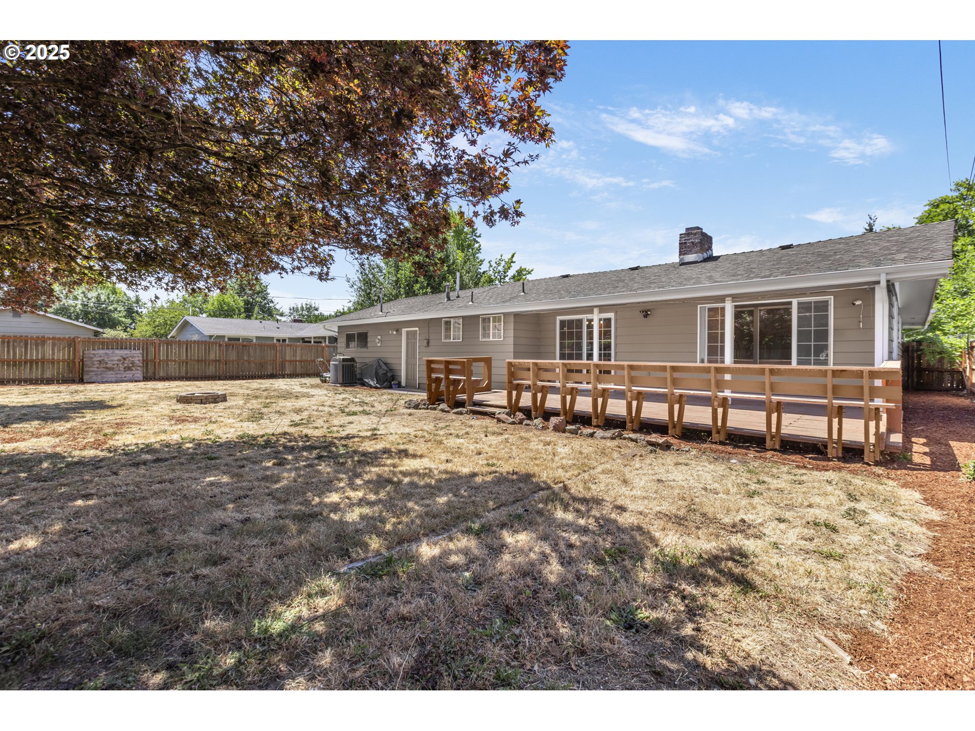 457 Archie Street Eugene, OR 97402 - Photo 37 of 48 a view of a house with a wooden deck and a big yard