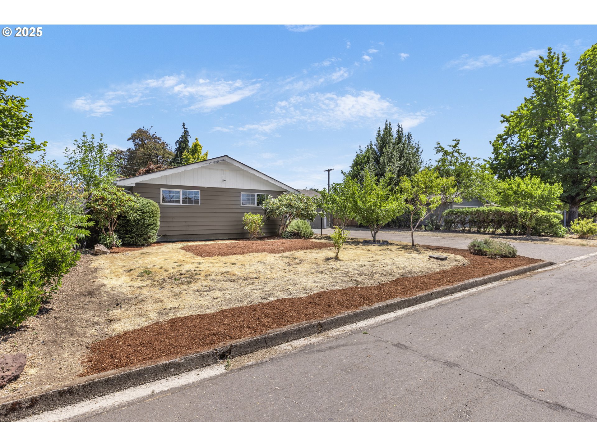 457 Archie Street Eugene, OR 97402 - Photo 46 of 48 a house with a yard and a large parking space