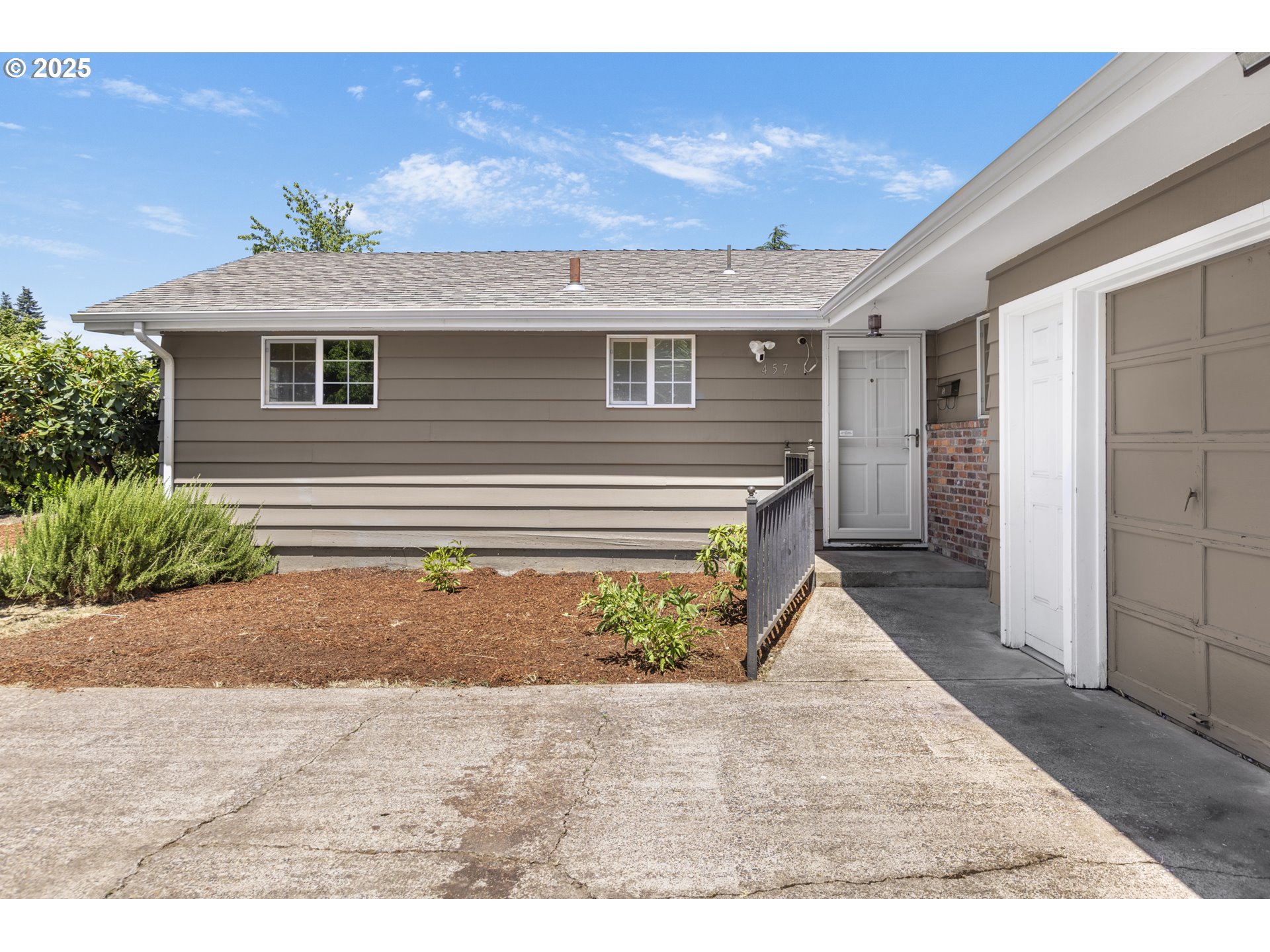 457 Archie Street Eugene, OR 97402 - Photo 6 of 48 a front view of a house with a yard and garage