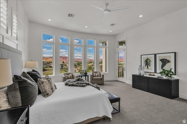 2608 Canyon Ridge Drive St. George, UT 84770 - Photo 31 of 86 Primary bedroom with full-height windows with a curved design, white shaker shutters, a private balcony, recessed lighting, and a ceiling fan