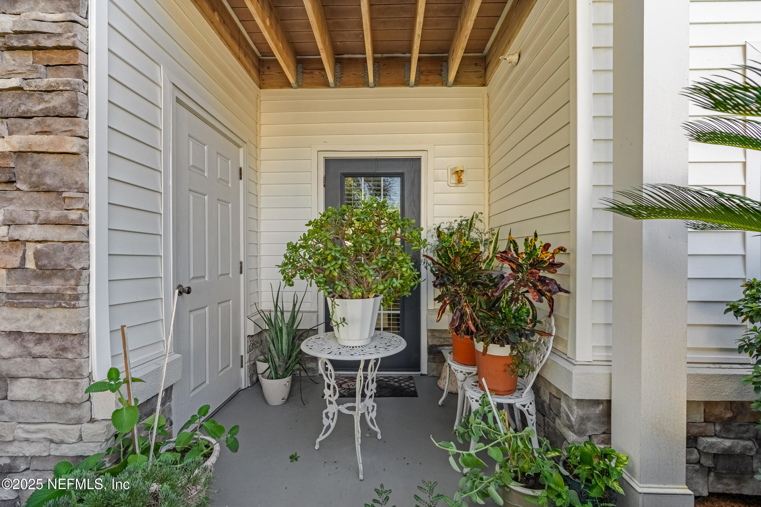 575 Oakleaf Plantation Parkway, Unit 1004 Orange Park, FL 32065 - Photo 12 of 22 a view of a chair and table in the patio
