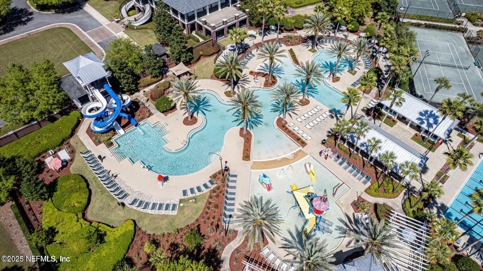 575 Oakleaf Plantation Parkway, Unit 1004 Orange Park, FL 32065 - Photo 18 of 22 an aerial view of a swimming pool a yard