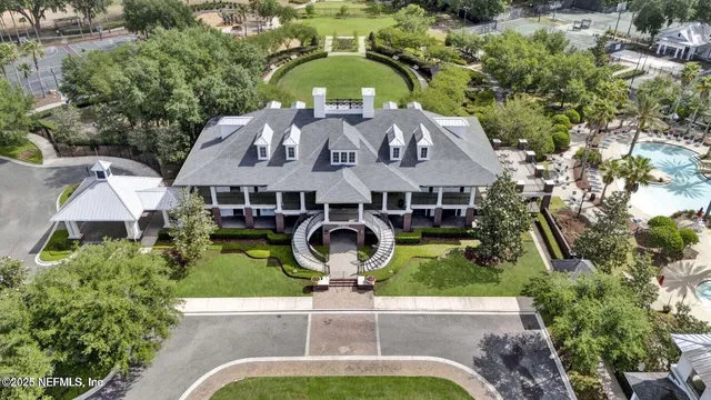 an aerial view of a house with garden space and trees