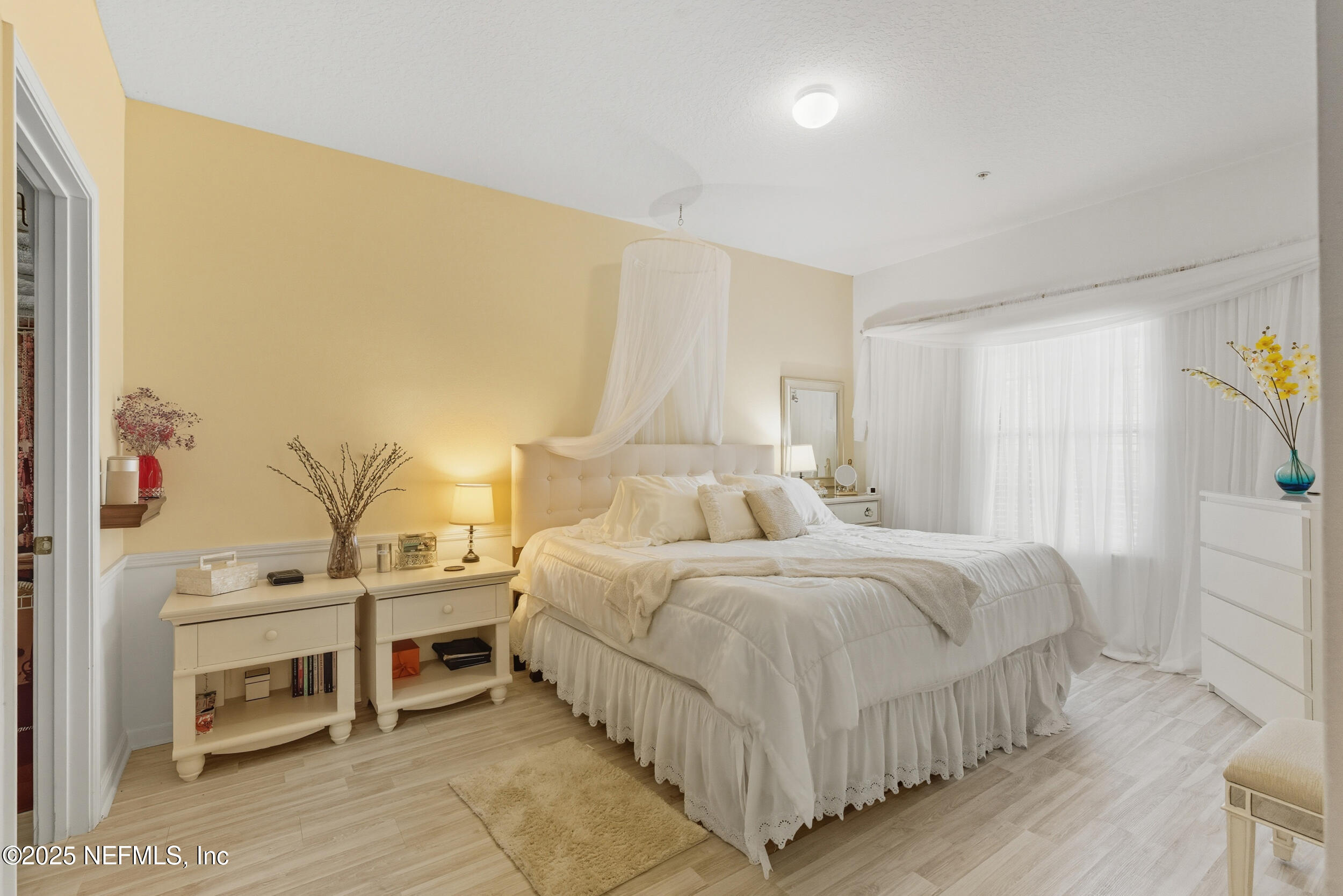 575 Oakleaf Plantation Parkway, Unit 1004 Orange Park, FL 32065 - Photo 6 of 22 a bedroom with a bed and a cabinets