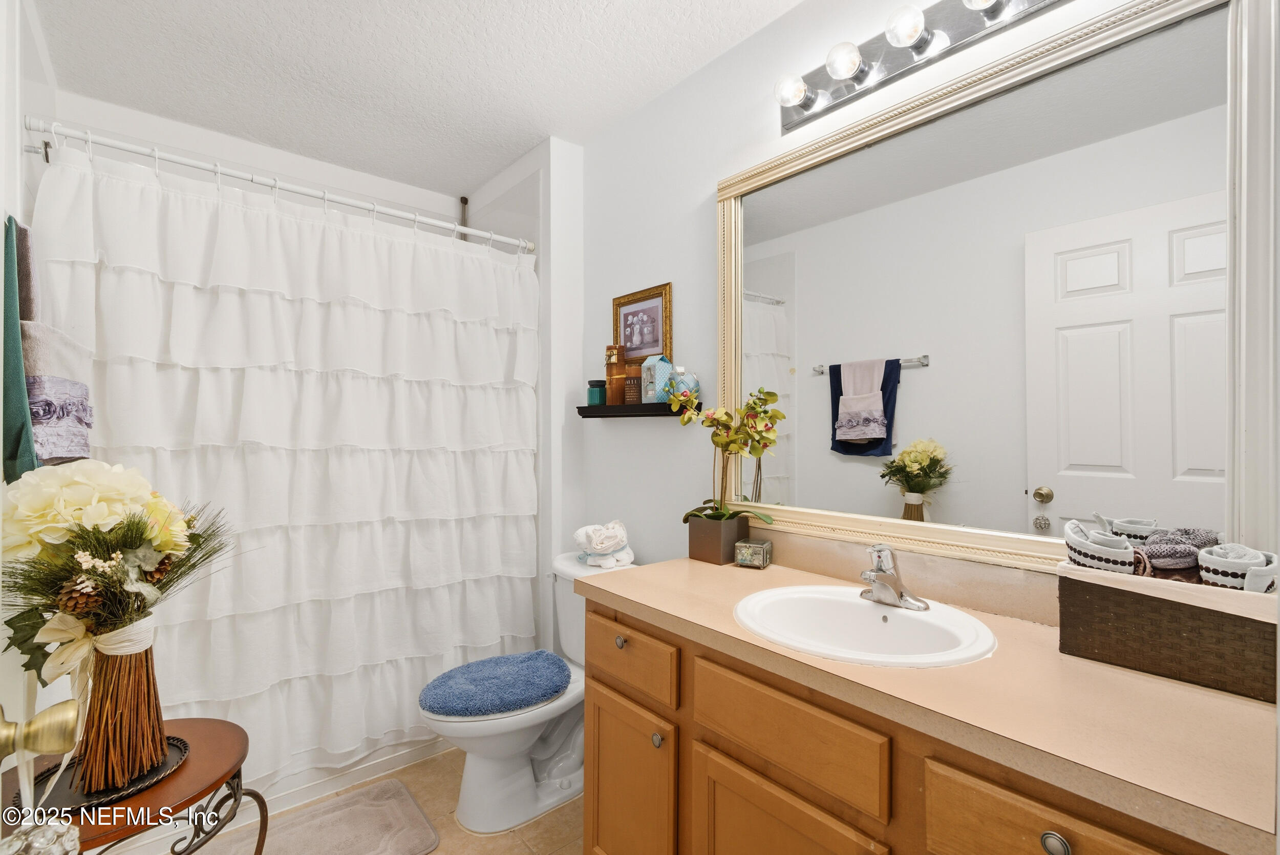 575 Oakleaf Plantation Parkway, Unit 1004 Orange Park, FL 32065 - Photo 10 of 22 a bathroom with a sink a toilet and shower