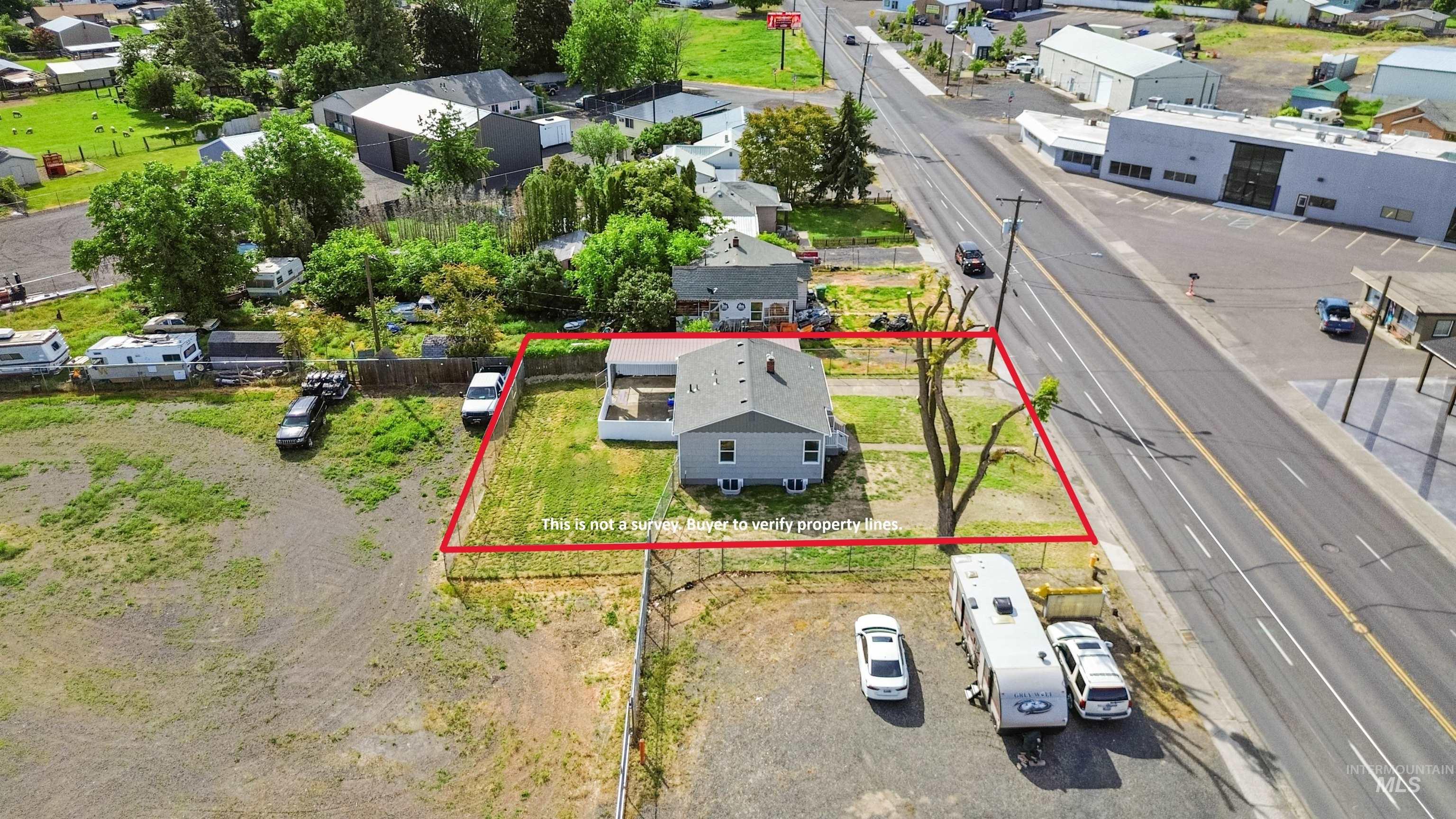 619 Thain Road Lewiston, ID 83501 - Photo 3 of 44 Single-story residence with a gray exterior, a dark shingle roof, and a grassy yard