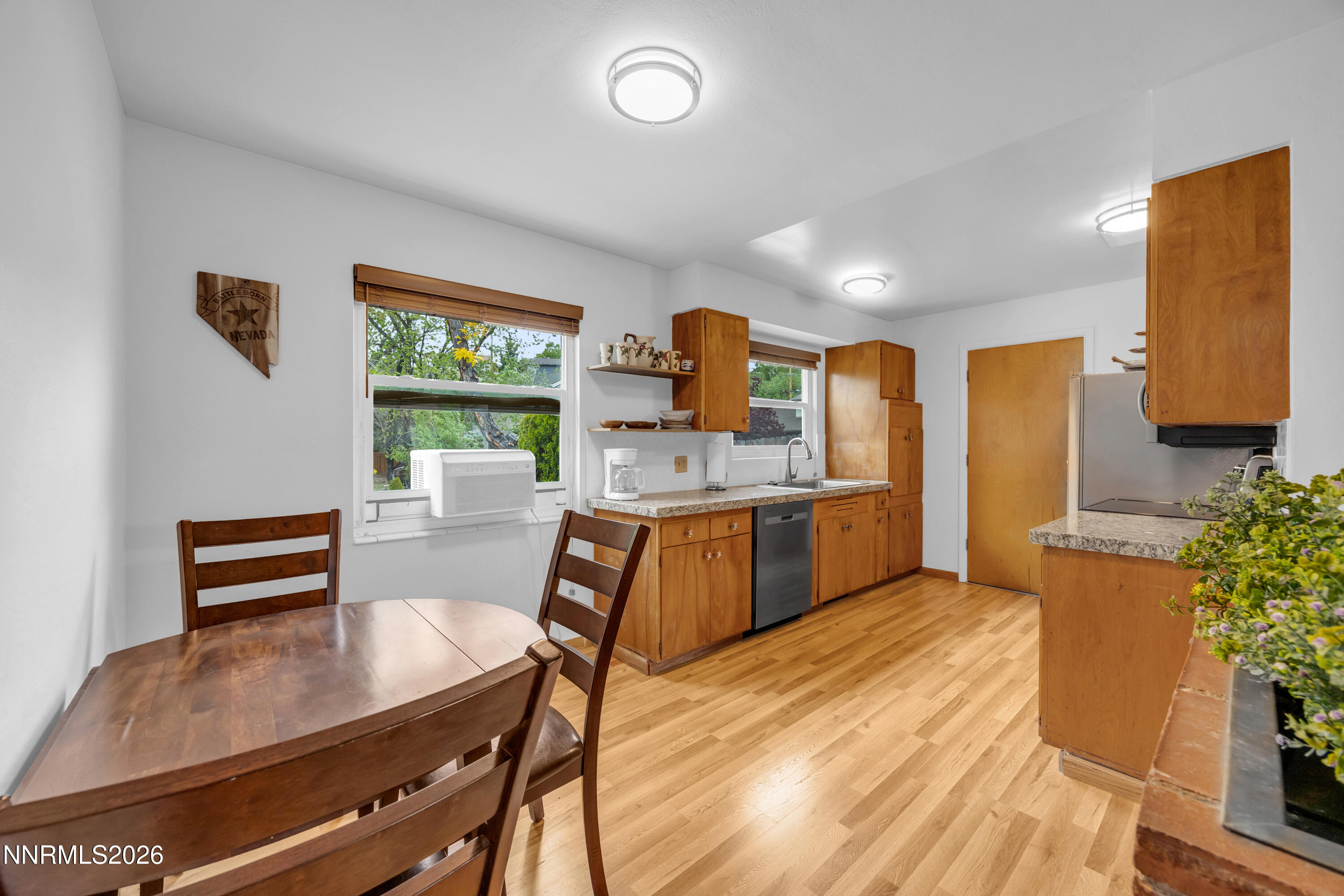 1208 Charles Drive Reno, NV 89509 - Photo 15 of 36 a kitchen with stainless steel appliances kitchen island granite countertop a stove a sink a refrigerator and a dining table