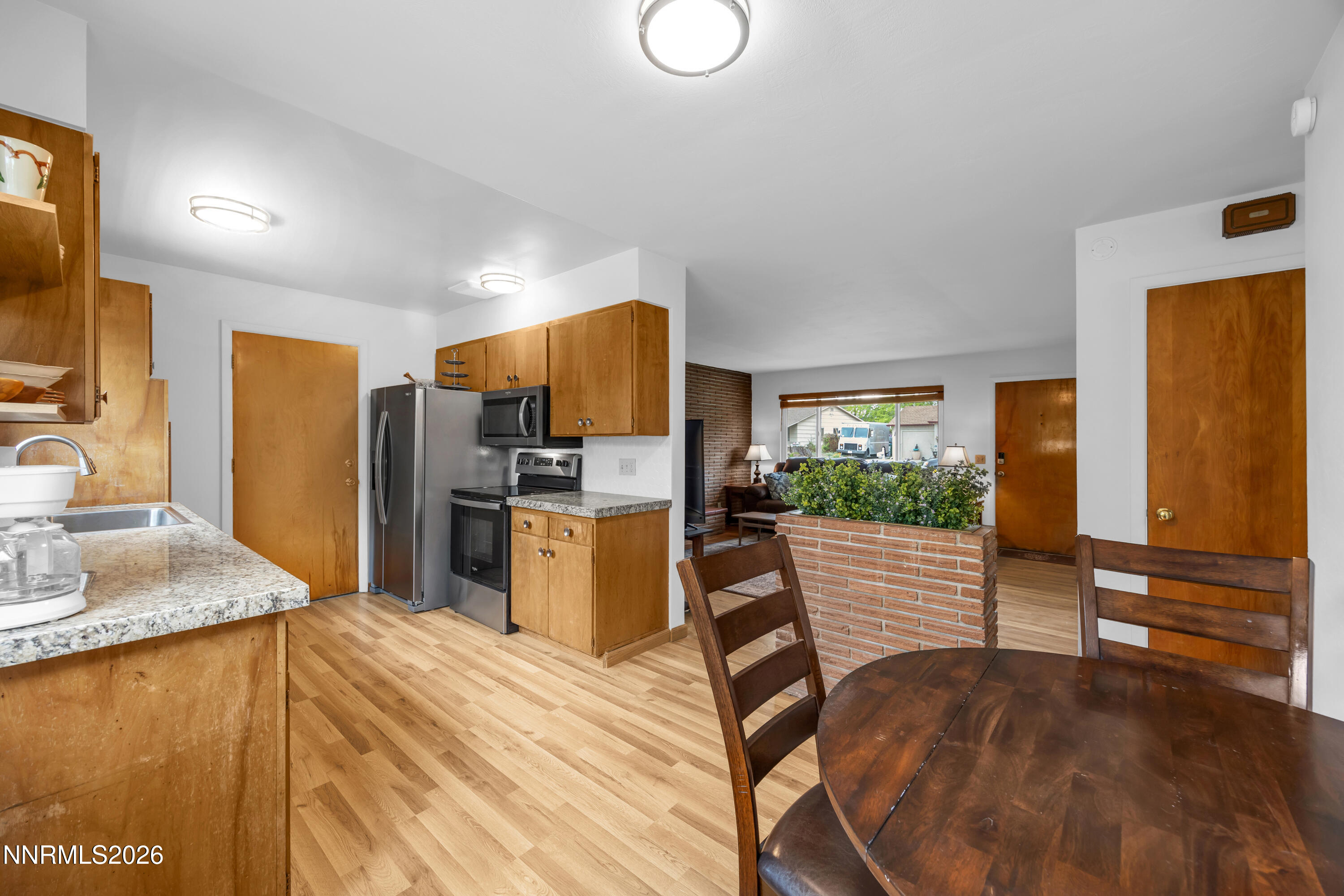 1208 Charles Drive Reno, NV 89509 - Photo 17 of 36 a kitchen with stainless steel appliances kitchen island granite countertop a stove and a sink