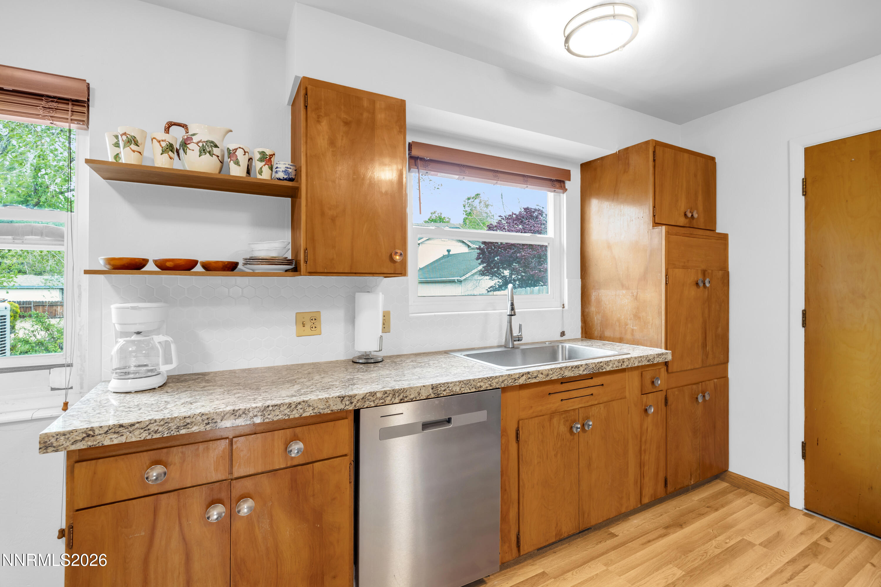 1208 Charles Drive Reno, NV 89509 - Photo 19 of 36 a kitchen with stainless steel appliances granite countertop a sink stove and refrigerator