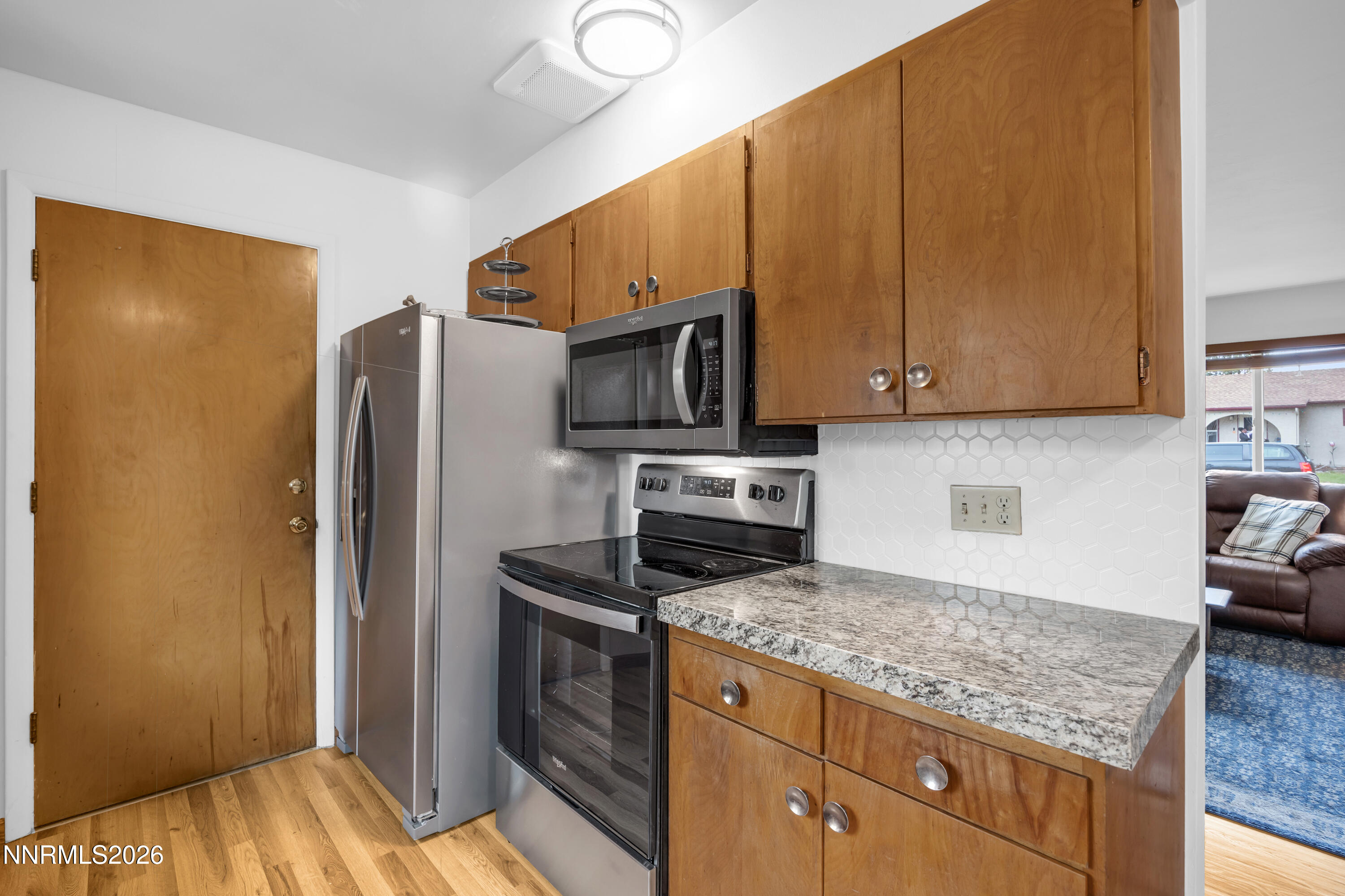 1208 Charles Drive Reno, NV 89509 - Photo 20 of 36 a kitchen with granite countertop wooden cabinets and stainless steel appliances