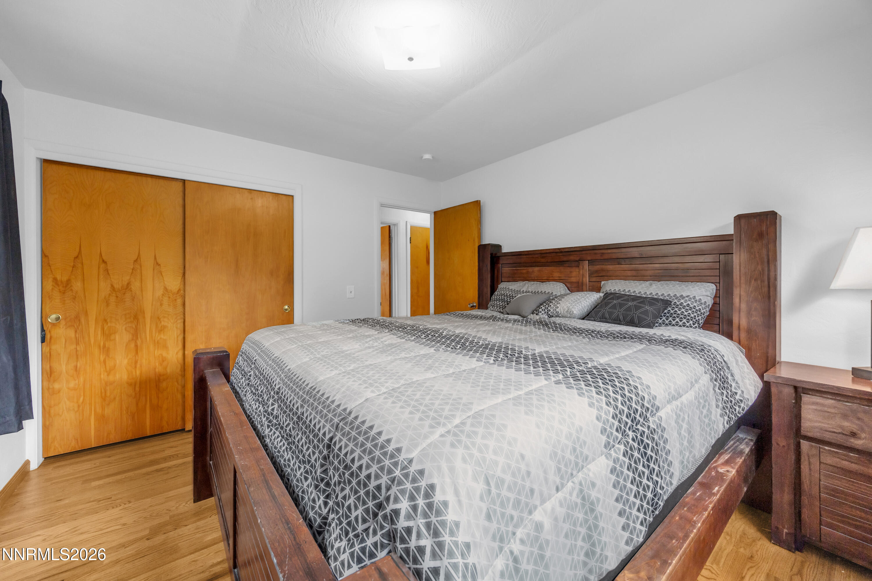 1208 Charles Drive Reno, NV 89509 - Photo 24 of 36 a bedroom with a bed and wooden floor