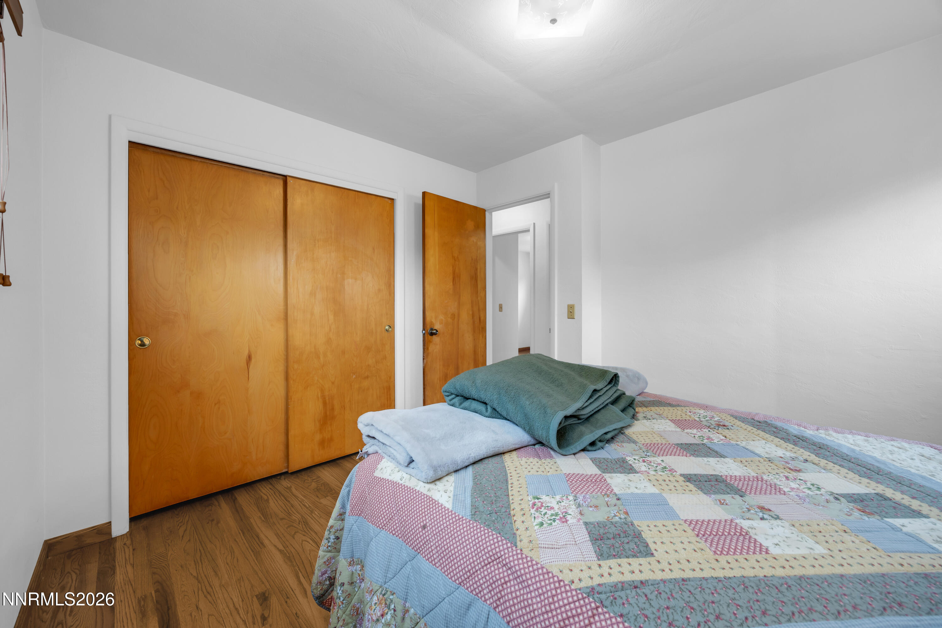 1208 Charles Drive Reno, NV 89509 - Photo 26 of 36 a bedroom with a bed and wooden floor