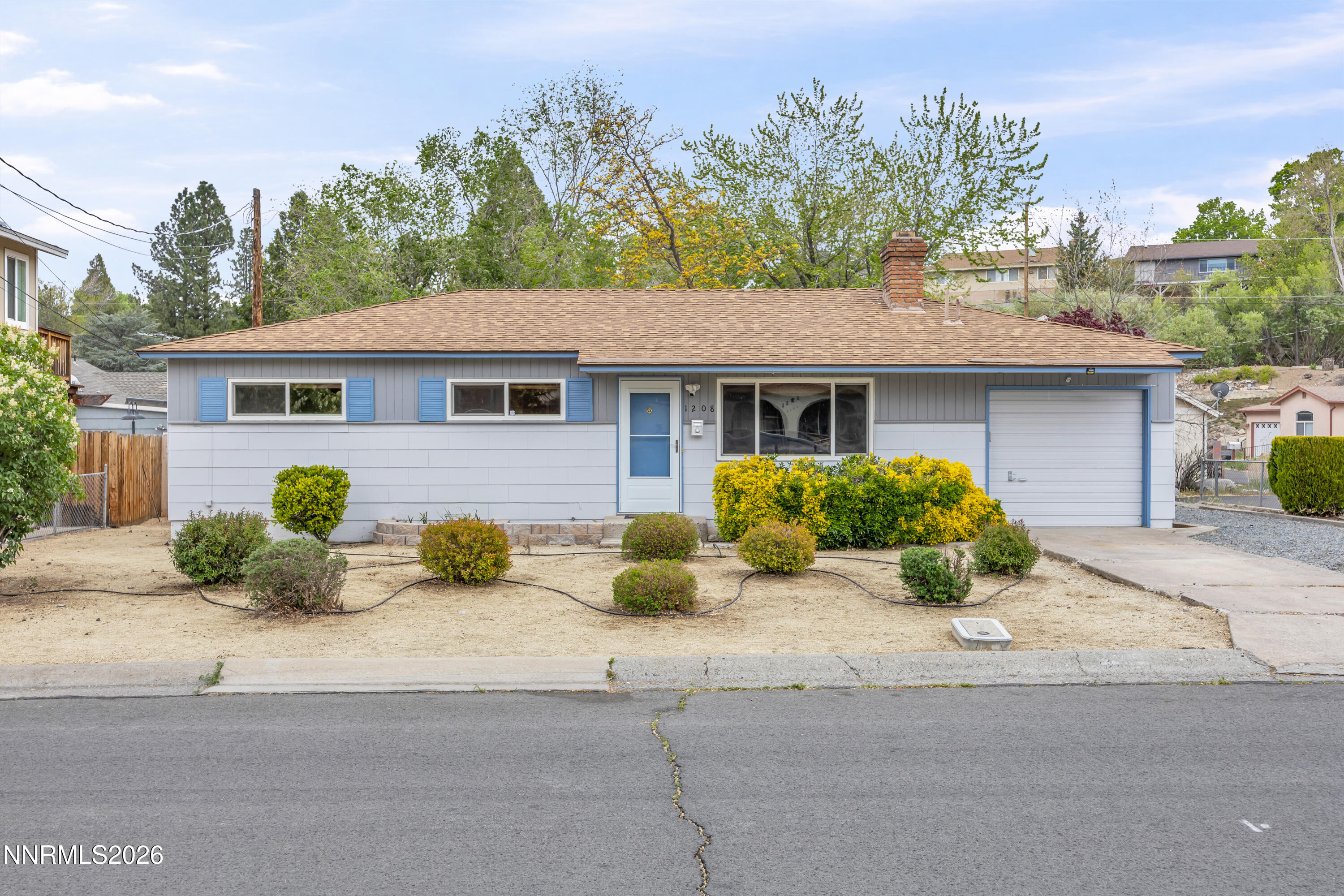 1208 Charles Drive Reno, NV 89509 - Photo 8 of 36 a front view of a house with a yard and potted plants
