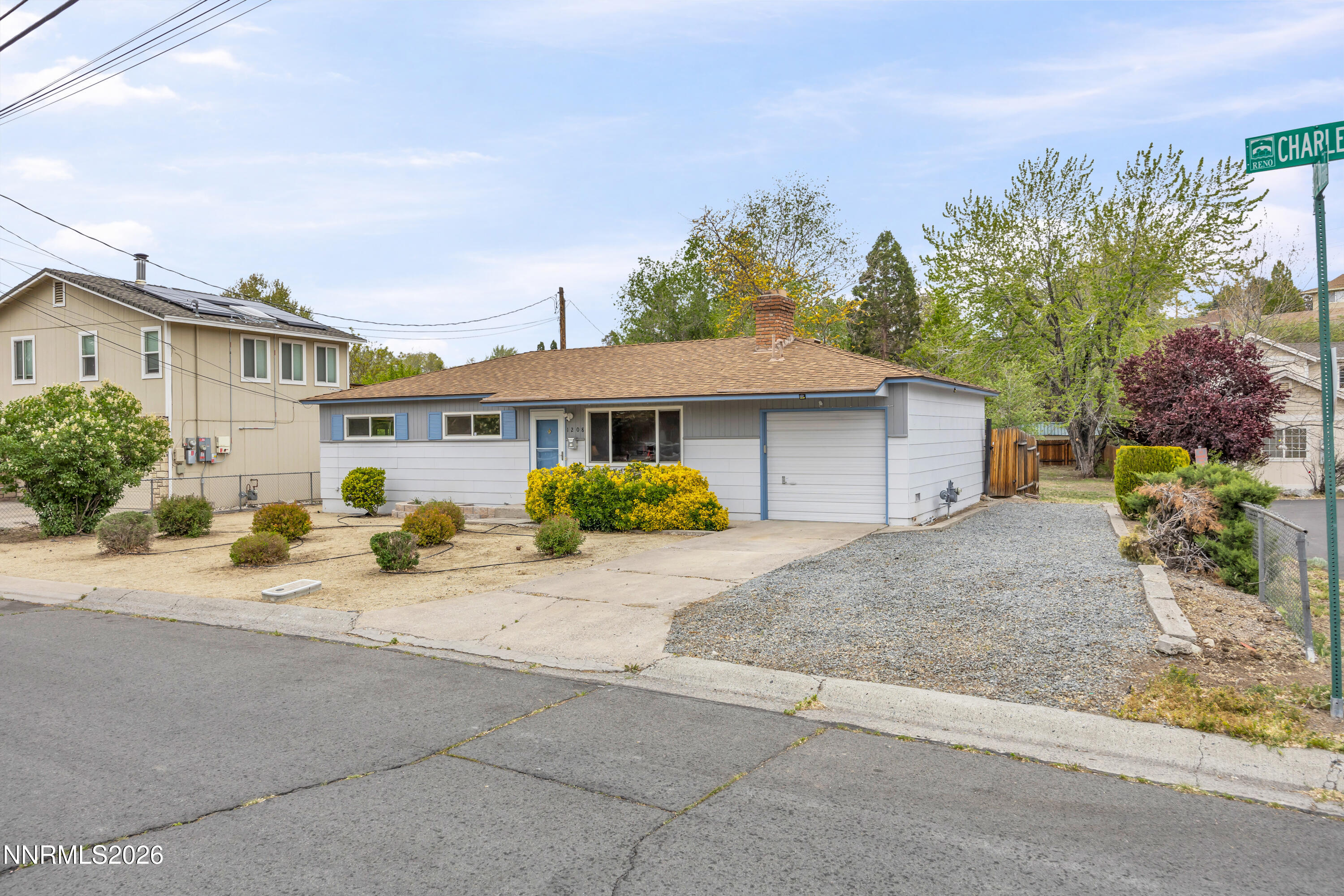 1208 Charles Drive Reno, NV 89509 - Photo 9 of 36 a front view of a house with a yard and garage