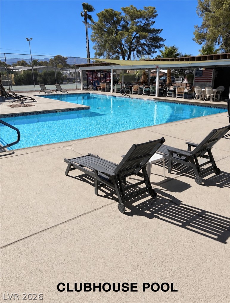 4556 Royal Ridge Way Las Vegas, NV 89103 - Photo 40 of 49 A spacious community swimming pool is surrounded by concrete decking and shady seating areas.