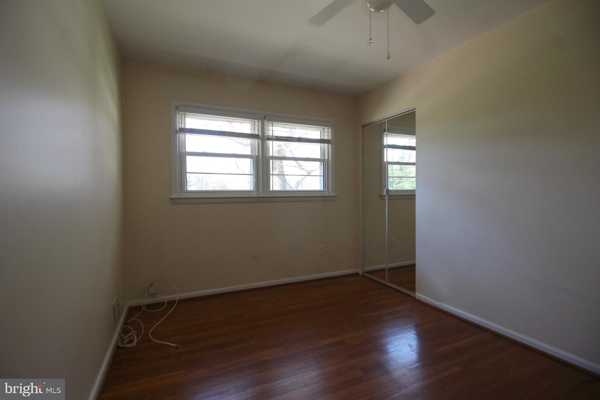 8504 Wagon Wheel Road Alexandria, VA 22309 - Photo 17 of 30 an empty room with wooden floor and windows