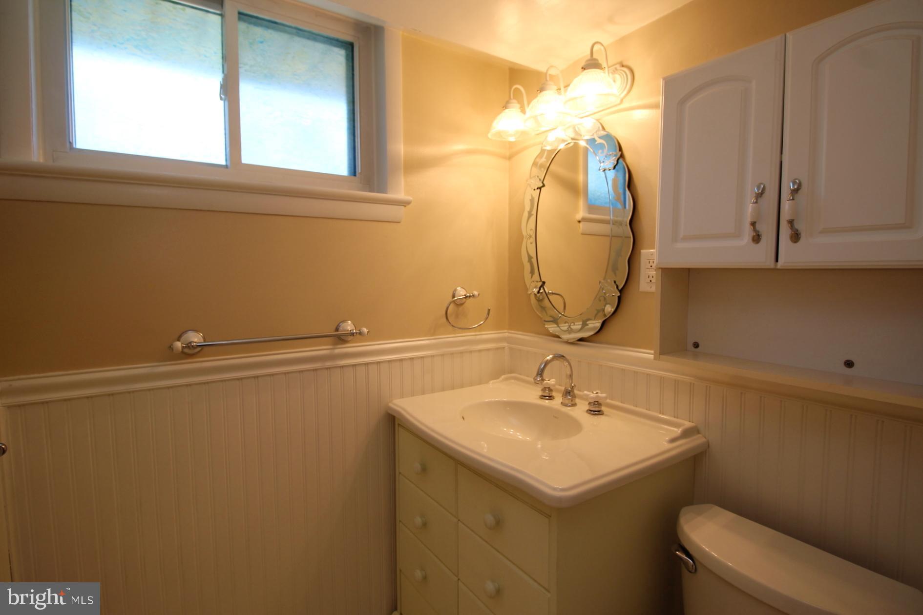 8504 Wagon Wheel Road Alexandria, VA 22309 - Photo 26 of 30 a bathroom with a sink vanity and a mirror