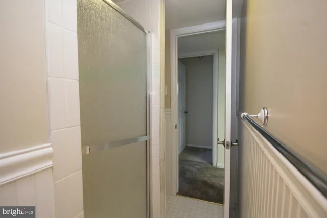 a bathroom with a glass door shower and a sink