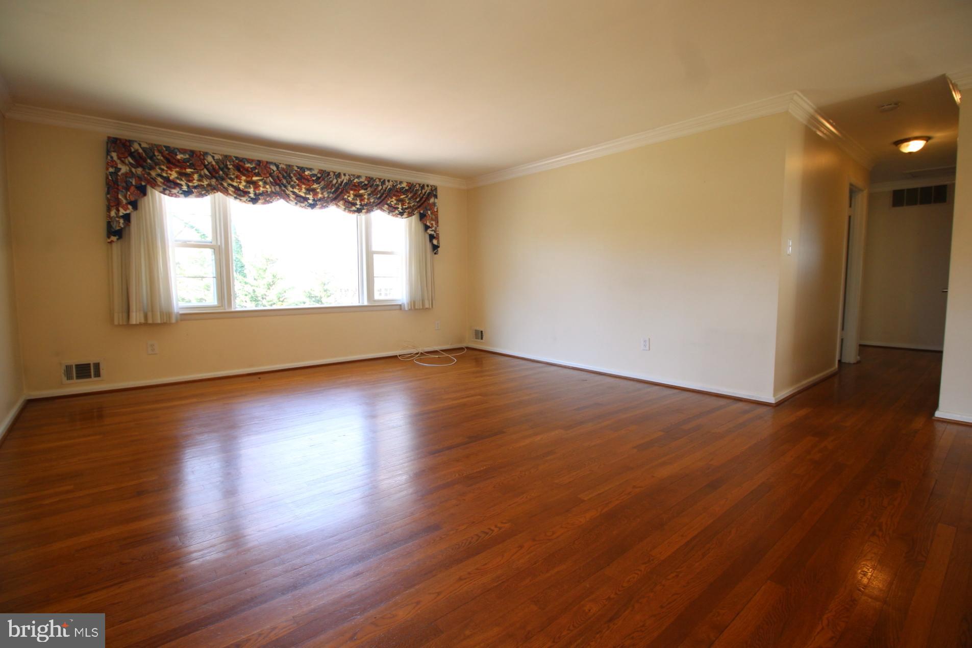 8504 Wagon Wheel Road Alexandria, VA 22309 - Photo 6 of 30 an empty room with wooden floor and windows