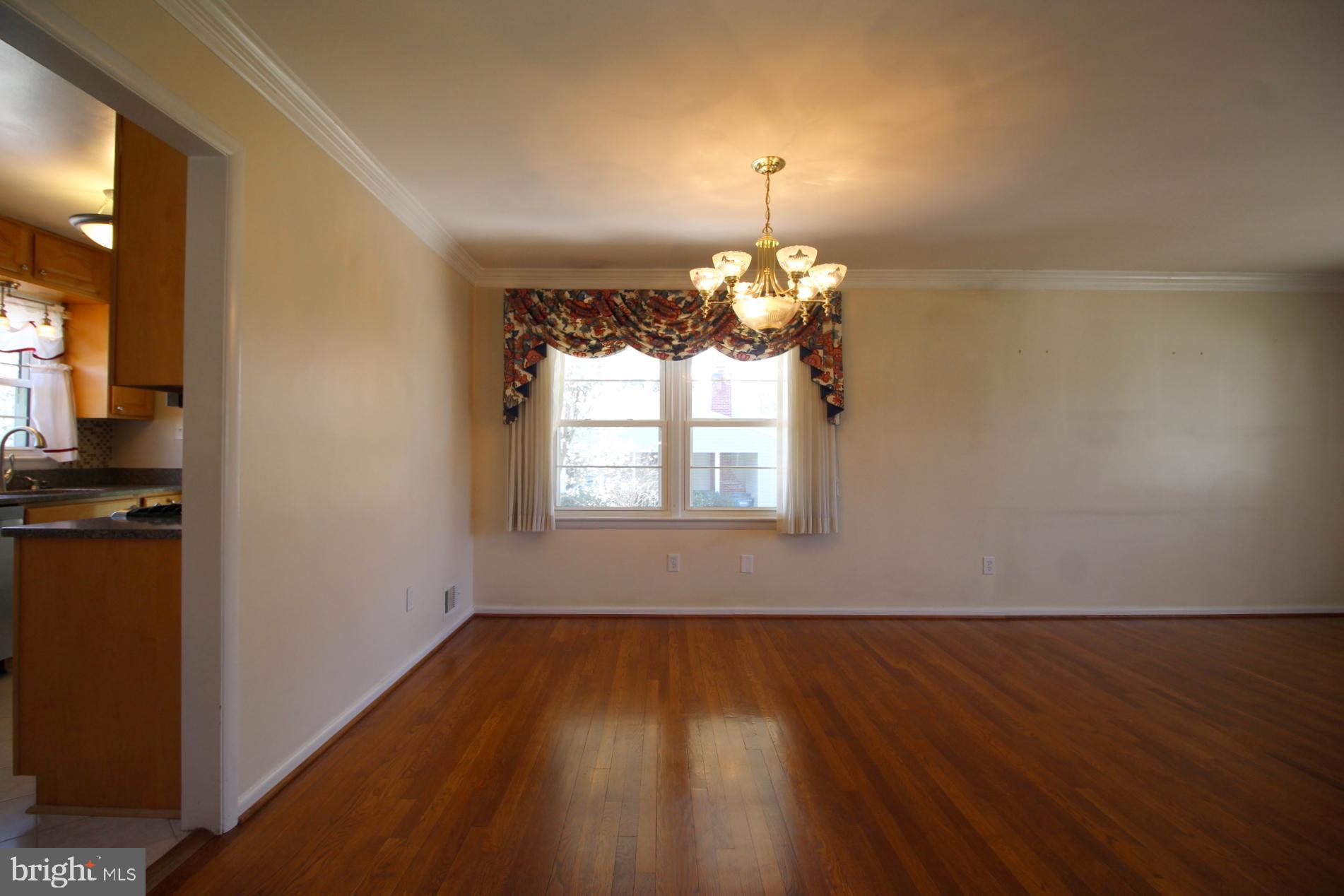 8504 Wagon Wheel Road Alexandria, VA 22309 - Photo 7 of 30 a view of a room with wooden floor chandelier and a window