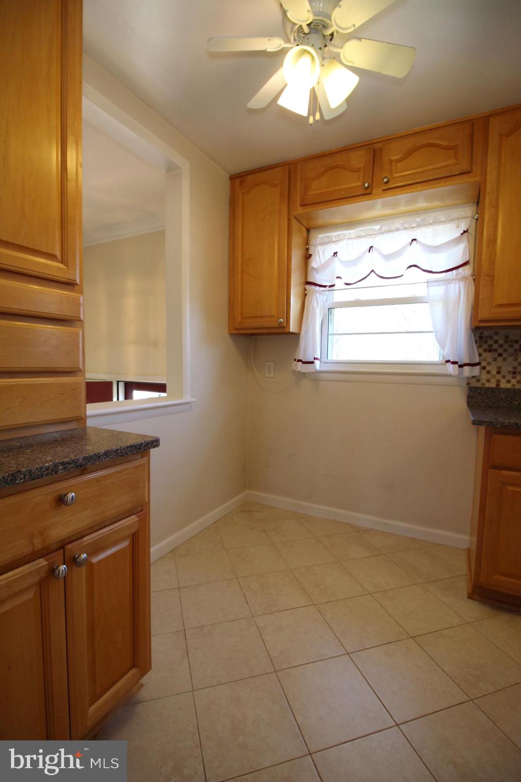 8504 Wagon Wheel Road Alexandria, VA 22309 - Photo 9 of 30 a bathroom with a sink a mirror and a window