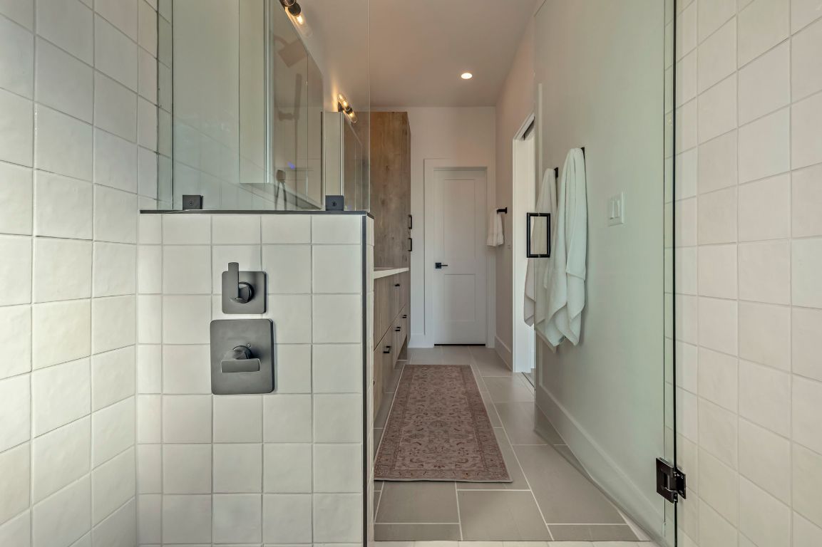 4601 Hank Avenue, Unit 1 Austin, TX 78745 - Photo 26 of 40 Full bath featuring a walk in shower, dual vanity, light tile patterned floors, and recessed lighting