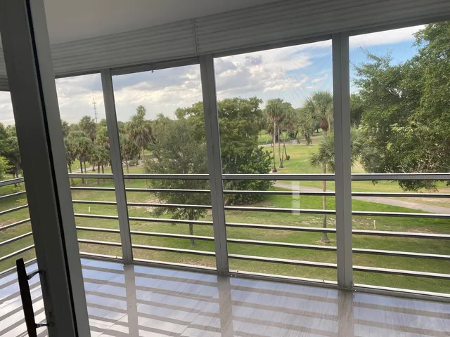 a view of a glass door with a green space