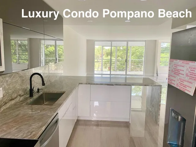 a kitchen with granite countertop a sink a stove and cabinets