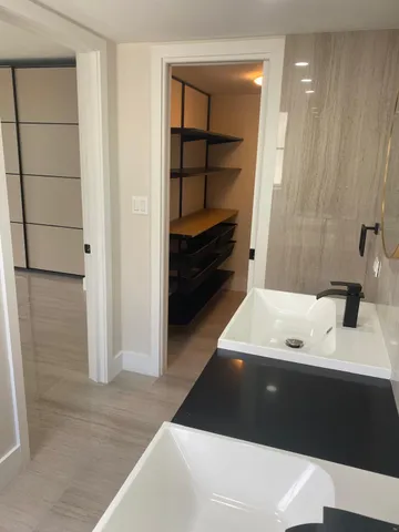 a picture of a room with a furniture and mirror