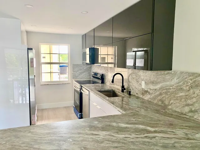 a view of a kitchen with a sink and a window
