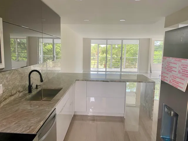 a kitchen with granite countertop a sink and a window