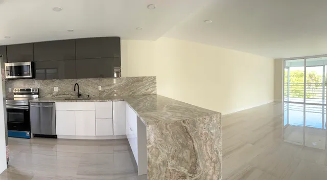 a kitchen with a sink and a stove top oven