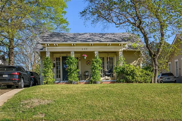 a view of a house with a large tree