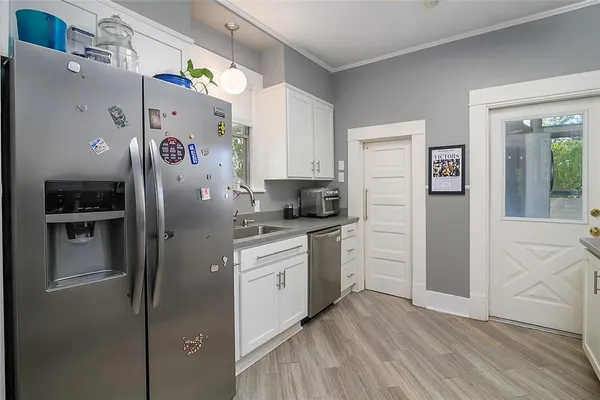 a kitchen with stainless steel appliances a refrigerator sink and microwave