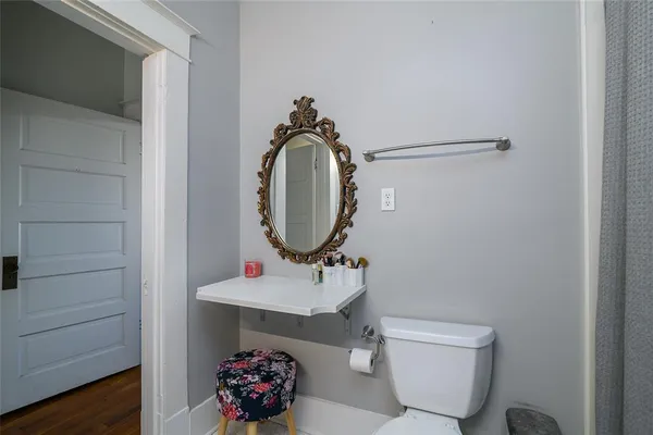 a bathroom with a toilet sink and mirror