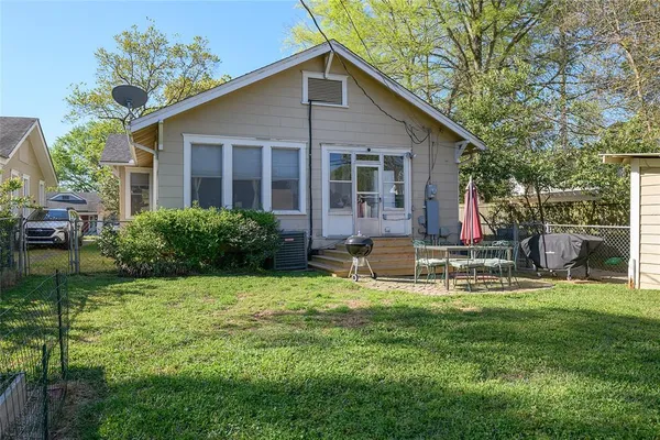 a view of a house with a yard and sitting area