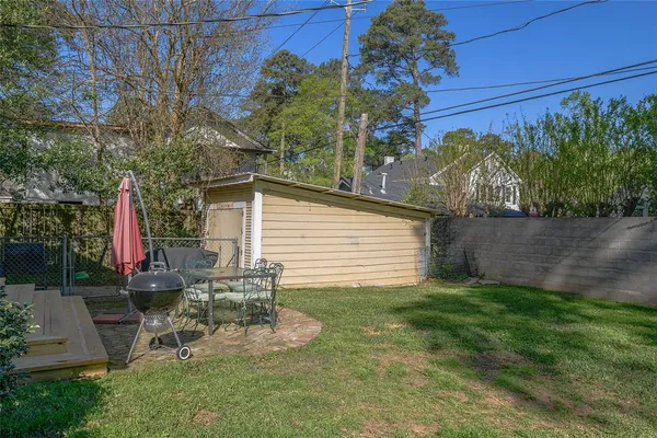 a view of a chair and table in backyard
