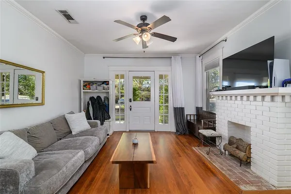 a living room with furniture fireplace and flat screen tv