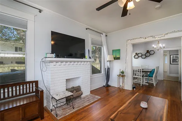 a living room with furniture a flat screen tv and a fireplace