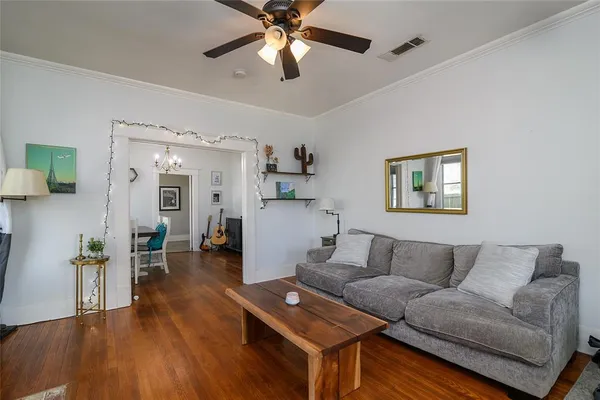 a living room with furniture and wooden floor