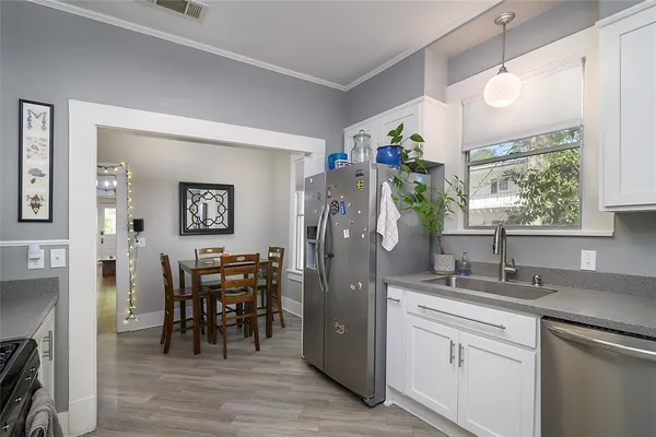 a kitchen with stainless steel appliances granite countertop a refrigerator and a sink