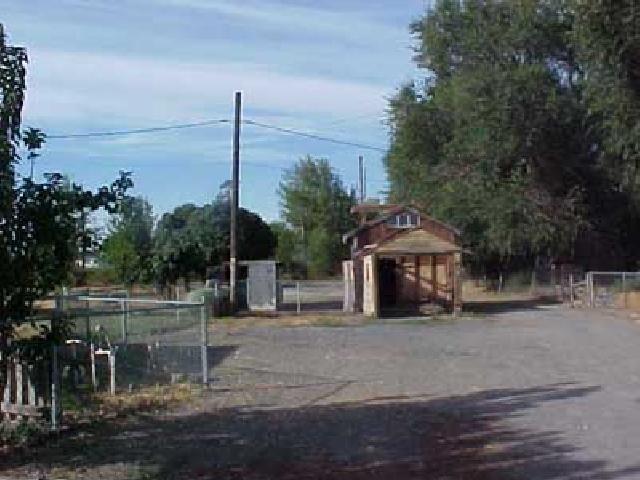 3101 Grandview Pavement Road Mabton, WA 98935 - Photo 5 of 6 a front view of a house with a garden and plants